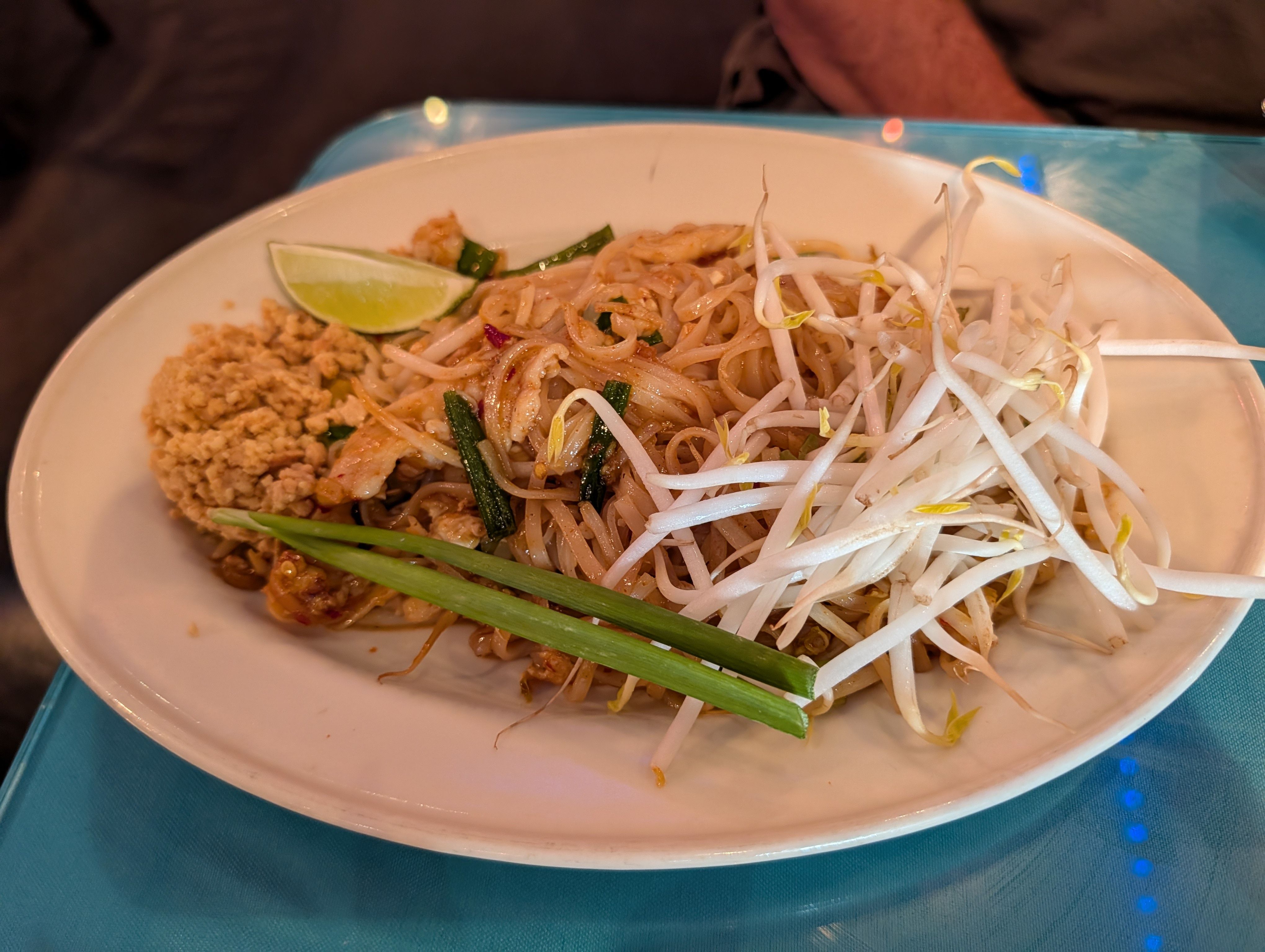 Pad Thai with bean sprouts, crushed peanuts, scallion and a lime wedge